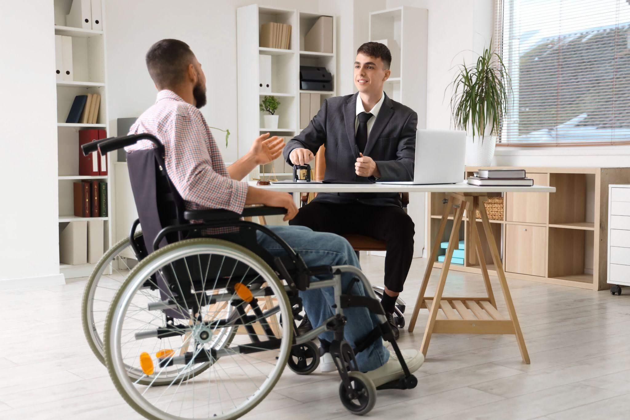 a man in a wheelchair talking to a man in a suit