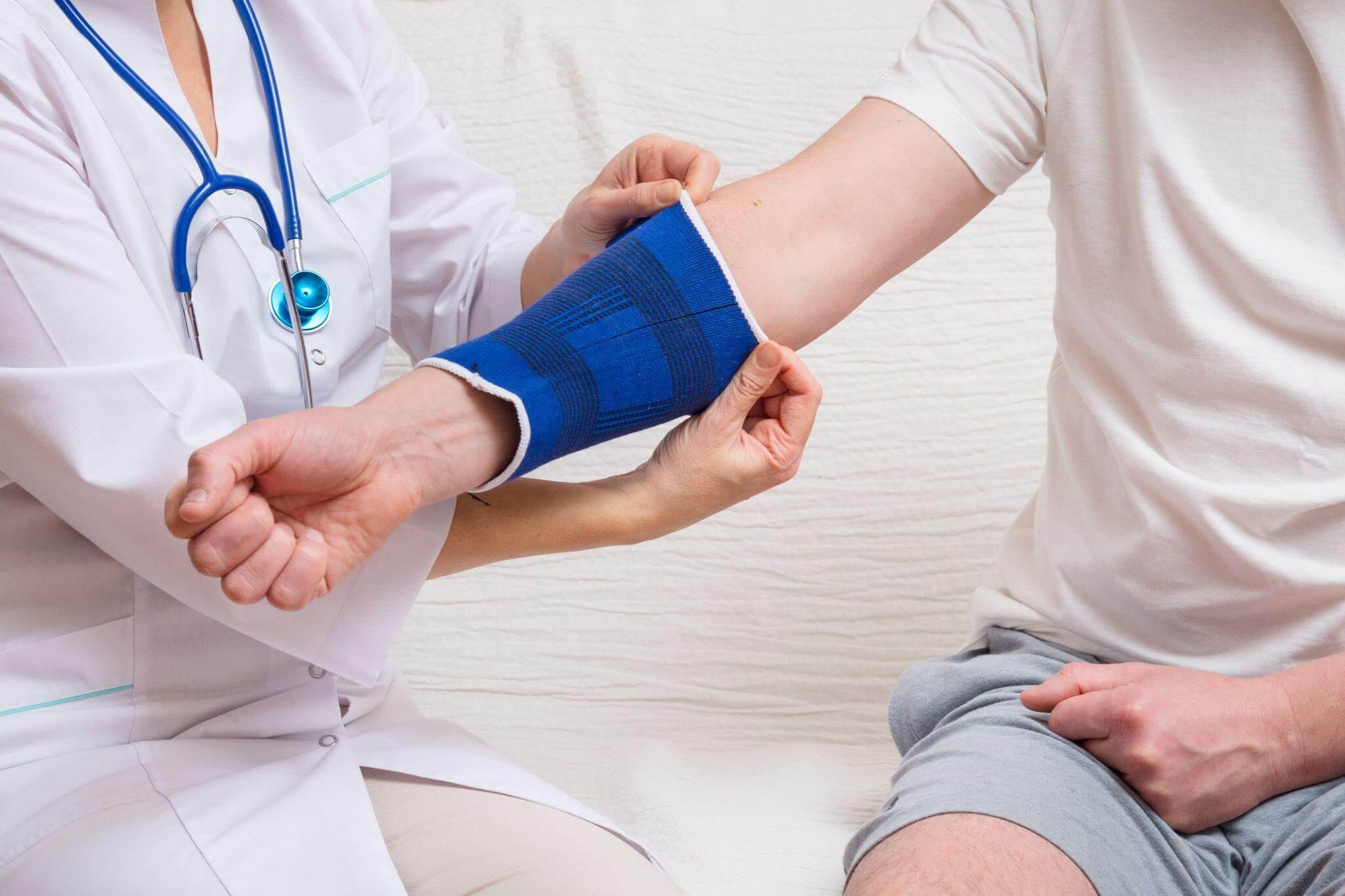 a doctor is placing a cast on somebody's arm