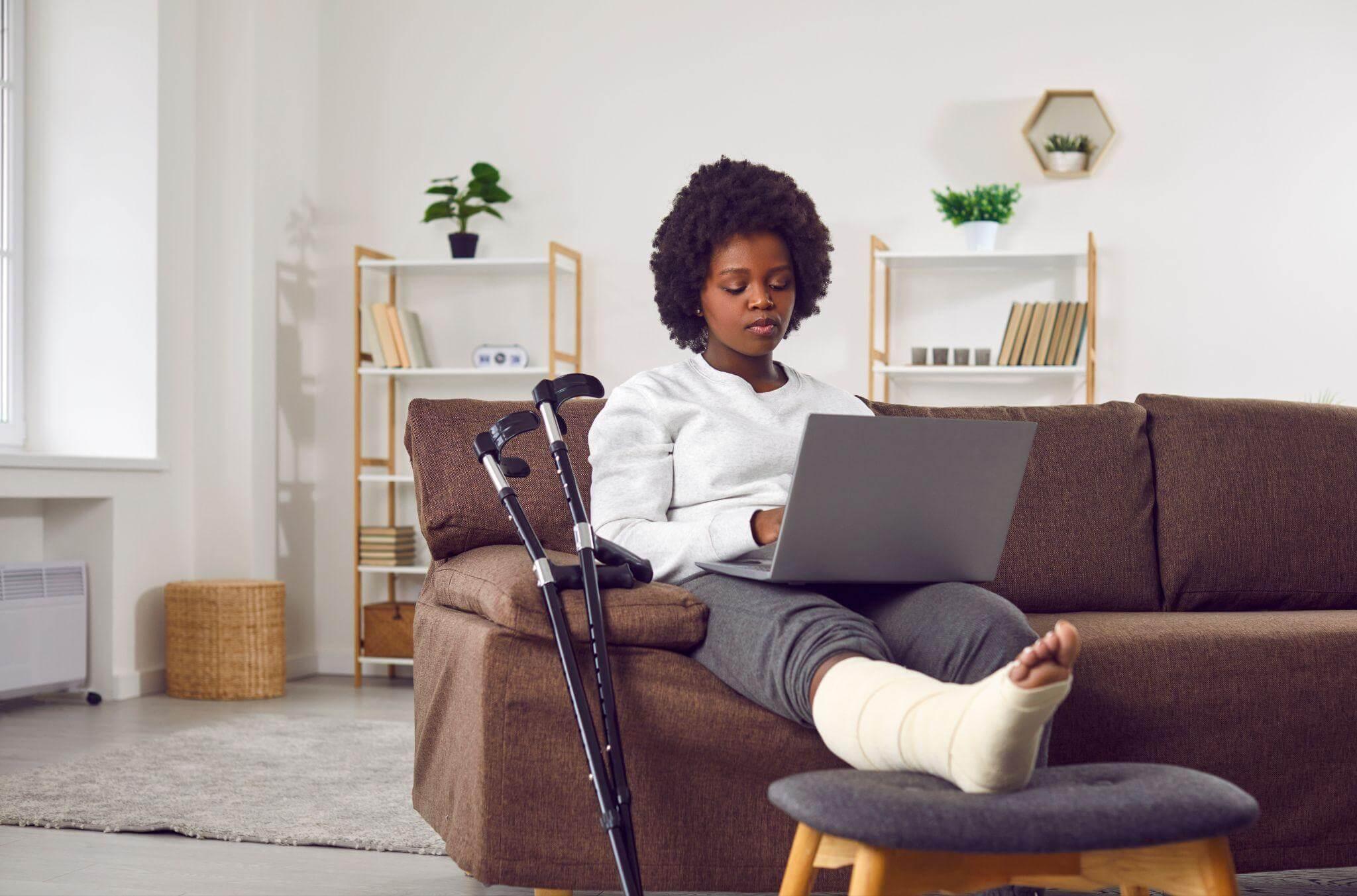a woman sitting on a couch using a laptop computer