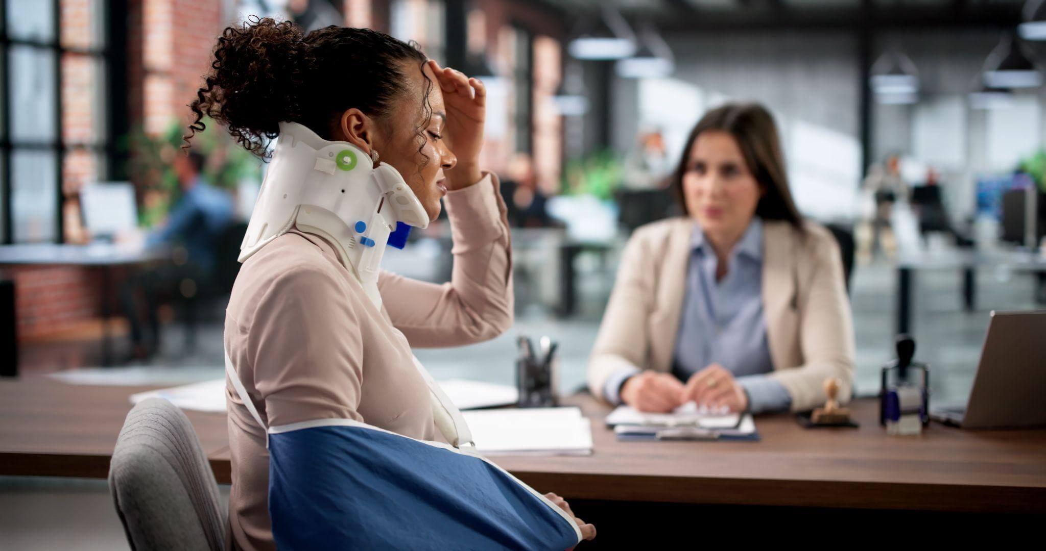 a woman sitting at a desk talking on a phone