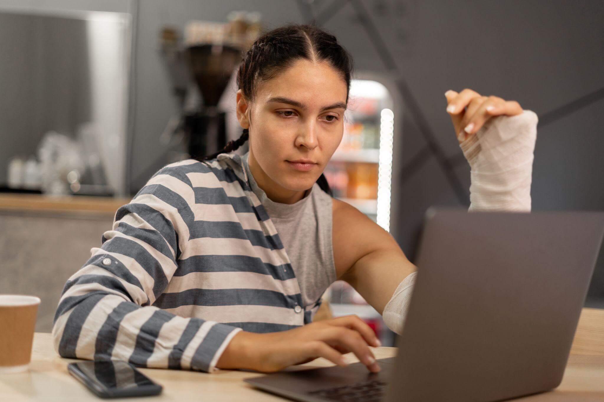 a woman sitting in front of a laptop computer