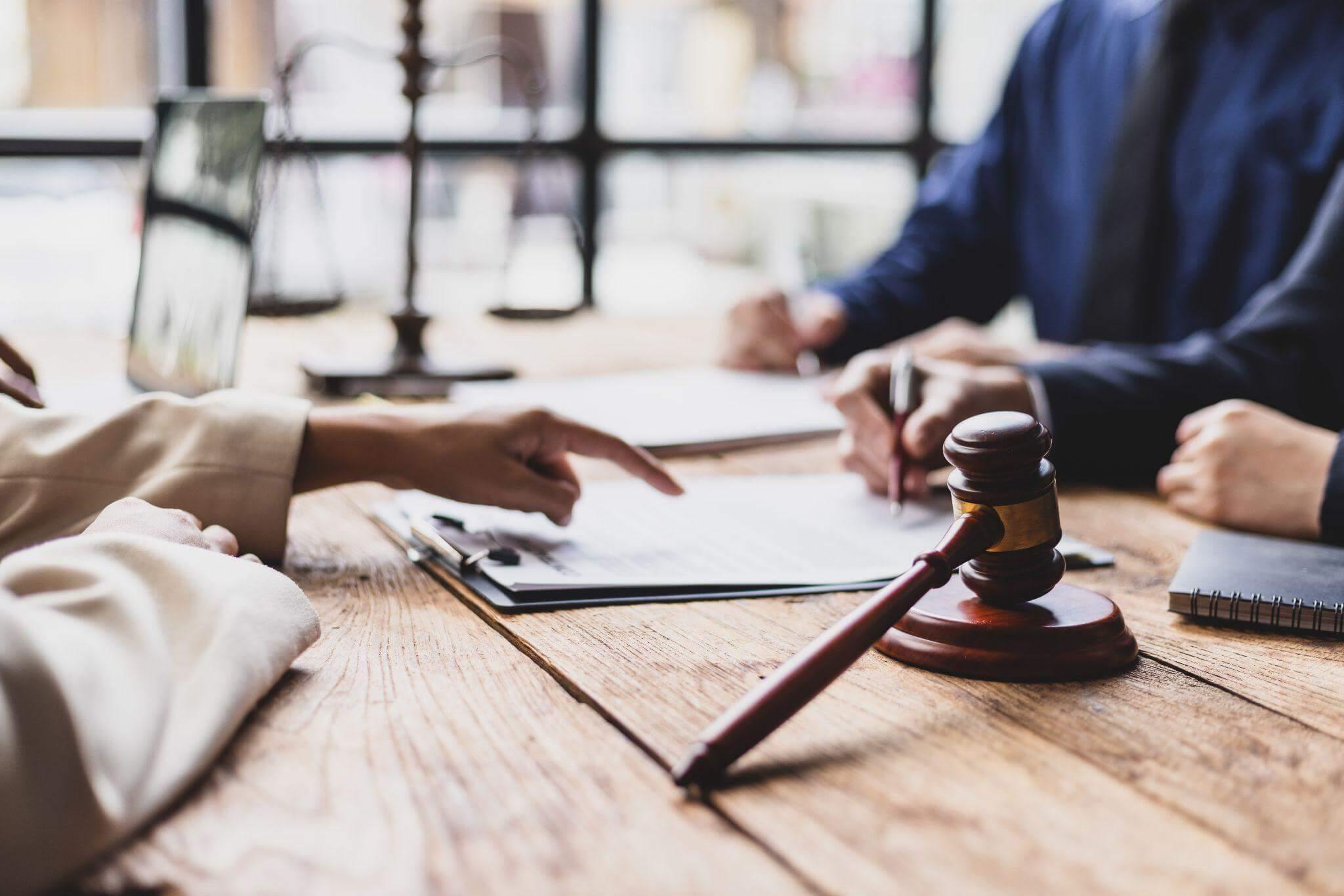 two people sitting at a table with a judge