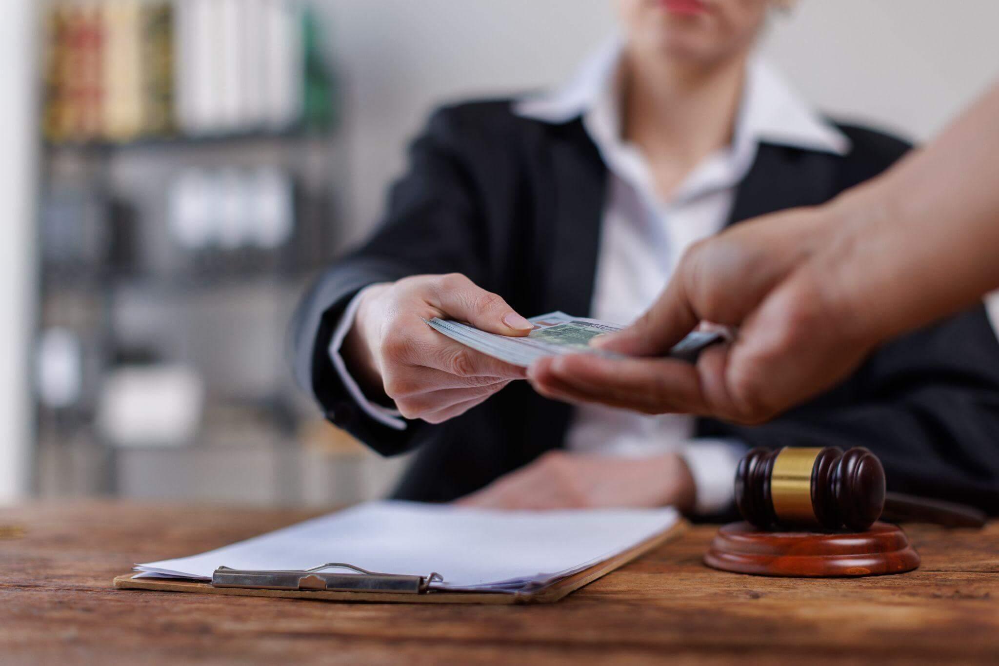 a judge handing a woman a piece of paper