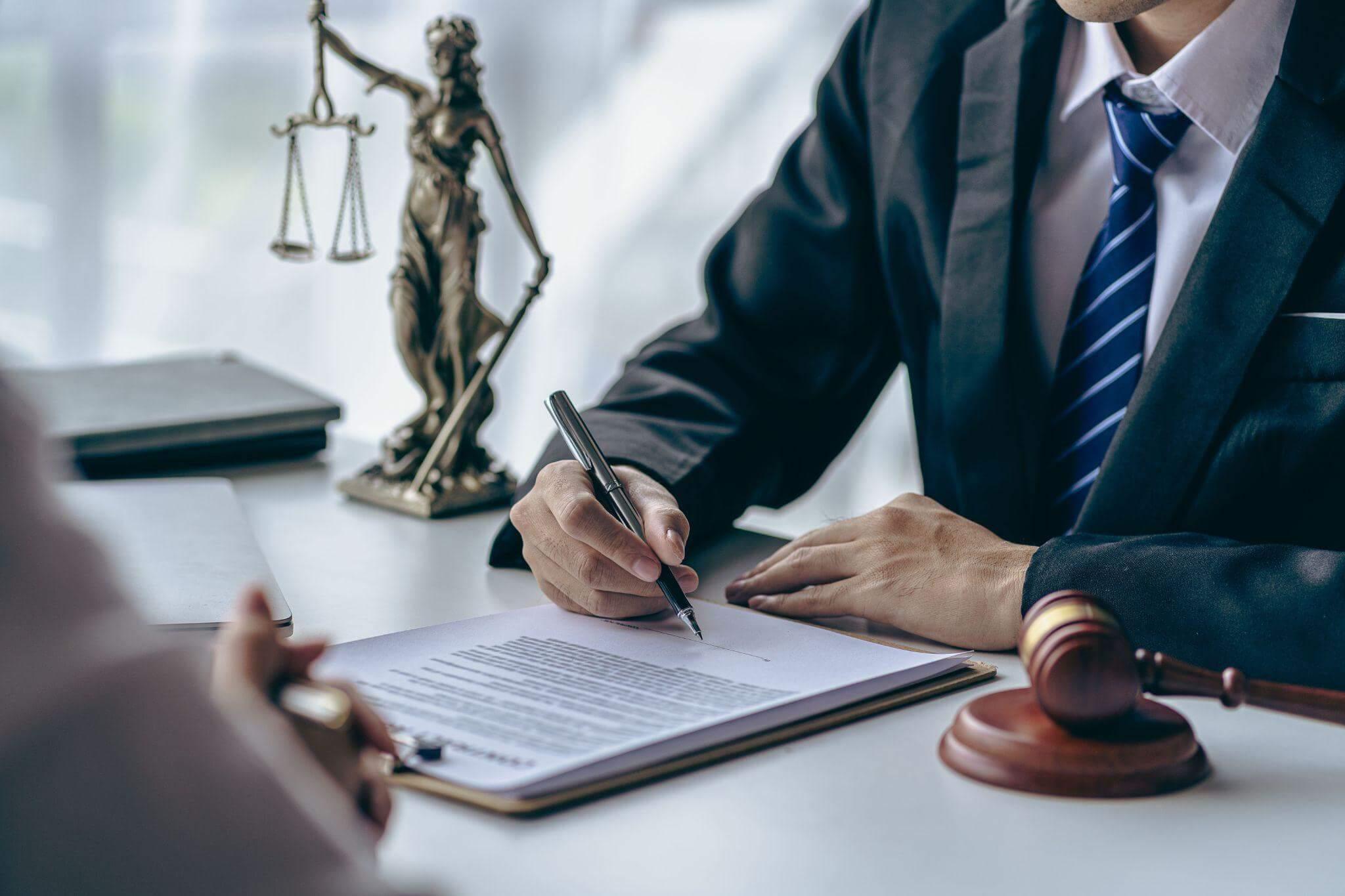 Man in business suit signing a legal
