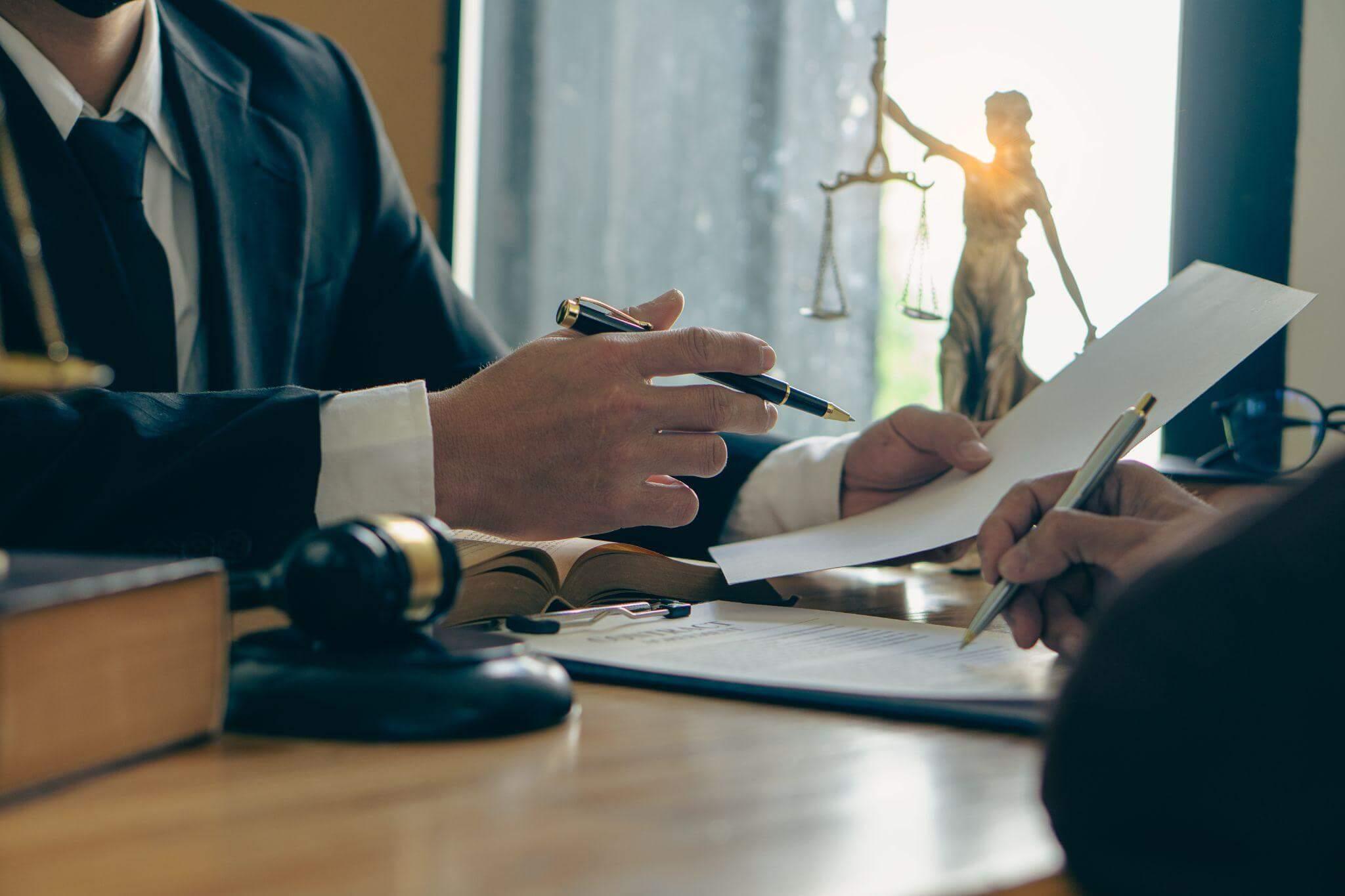 Two people at a table, possibly discussing legal matters