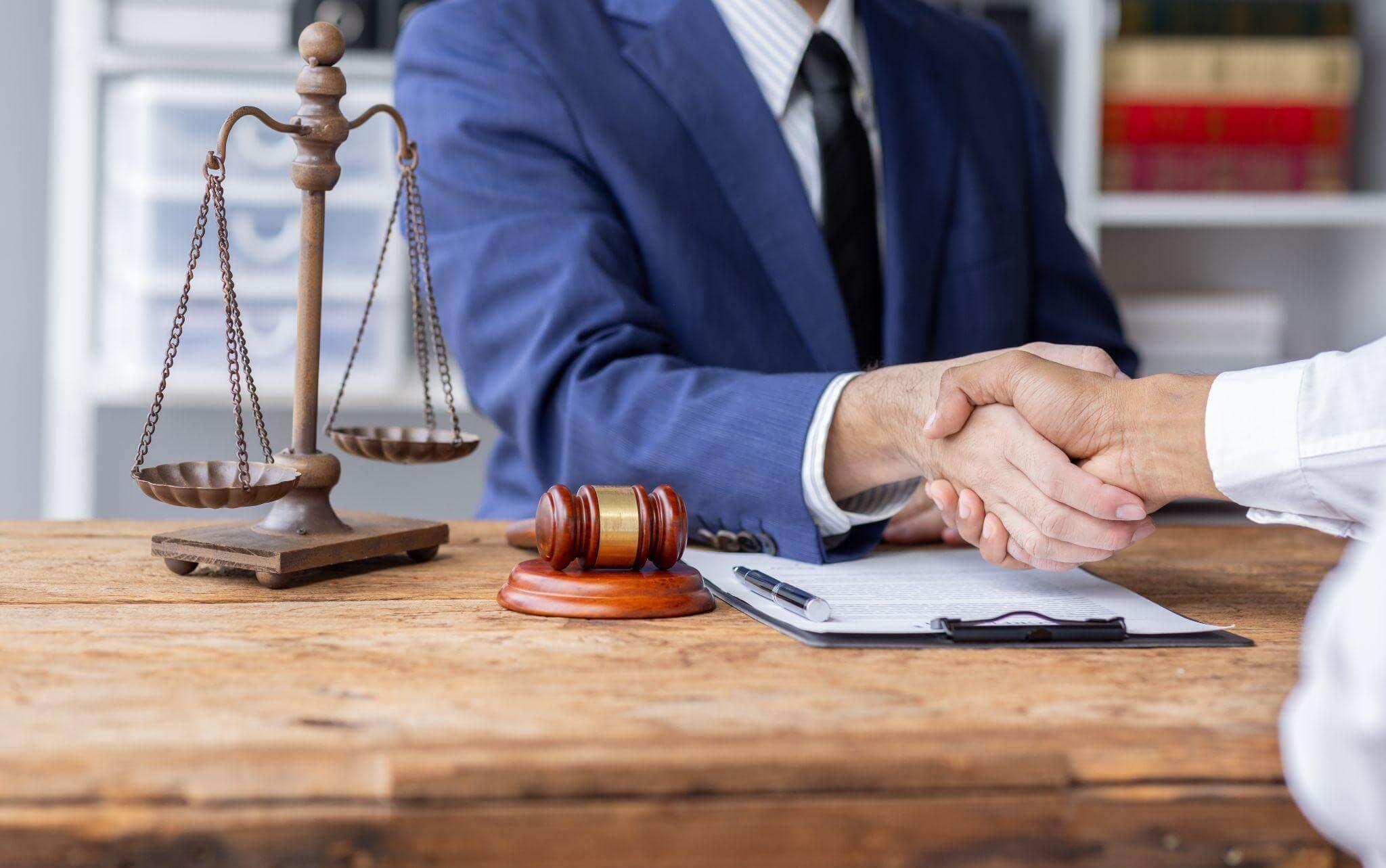 Lansing car accident lawyers shaking hands in front