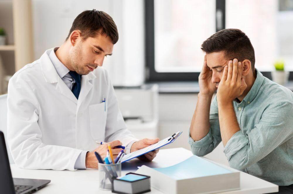 Two doctors review medical paperwork related to car accident symptoms