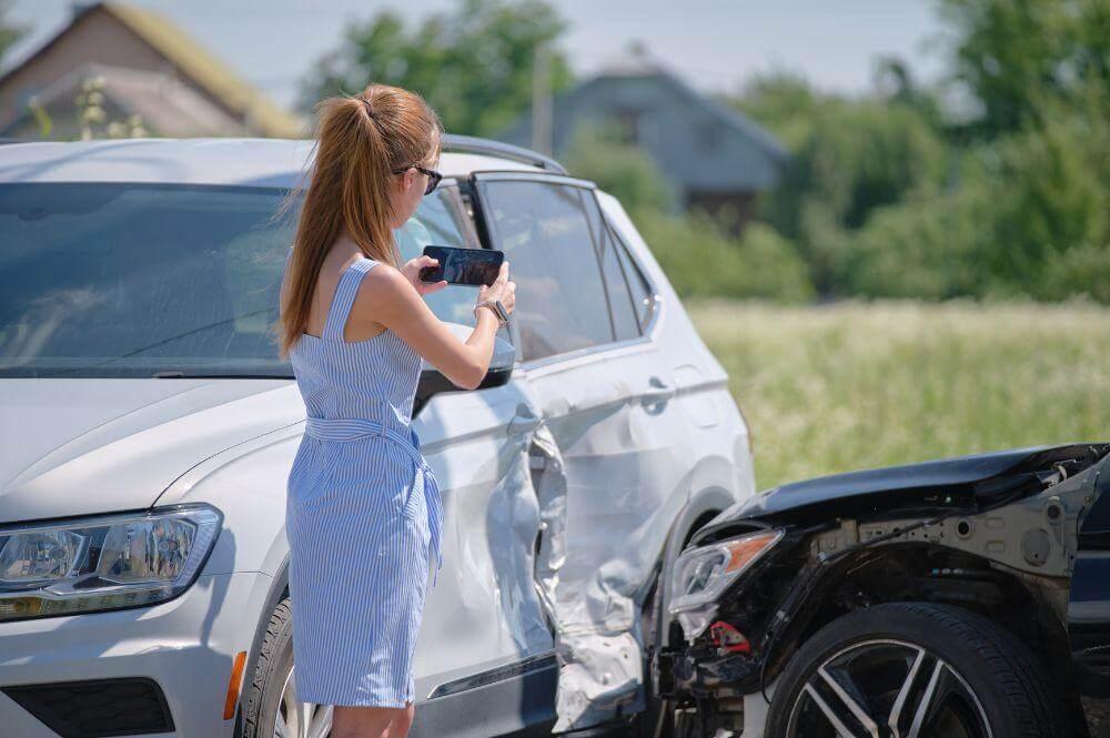 Woman looking at a car involved in an accident