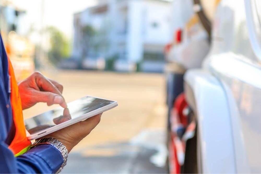 Person in blue jacket using a tablet